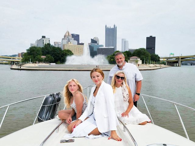 Chrisit Zook Lukasiak in a white one piece with her husband and children in white dresses.